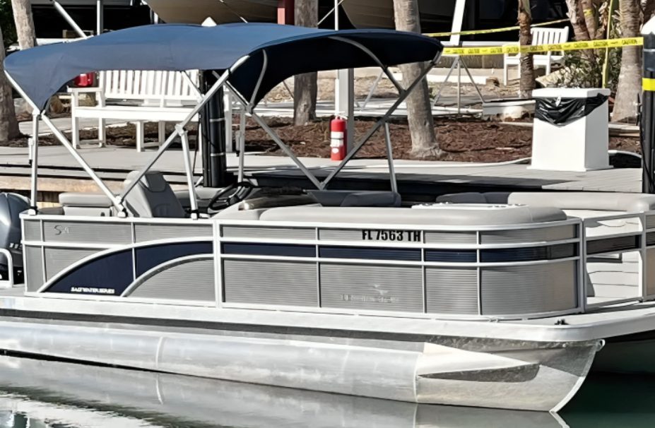 Pontoon boat docked by the water
